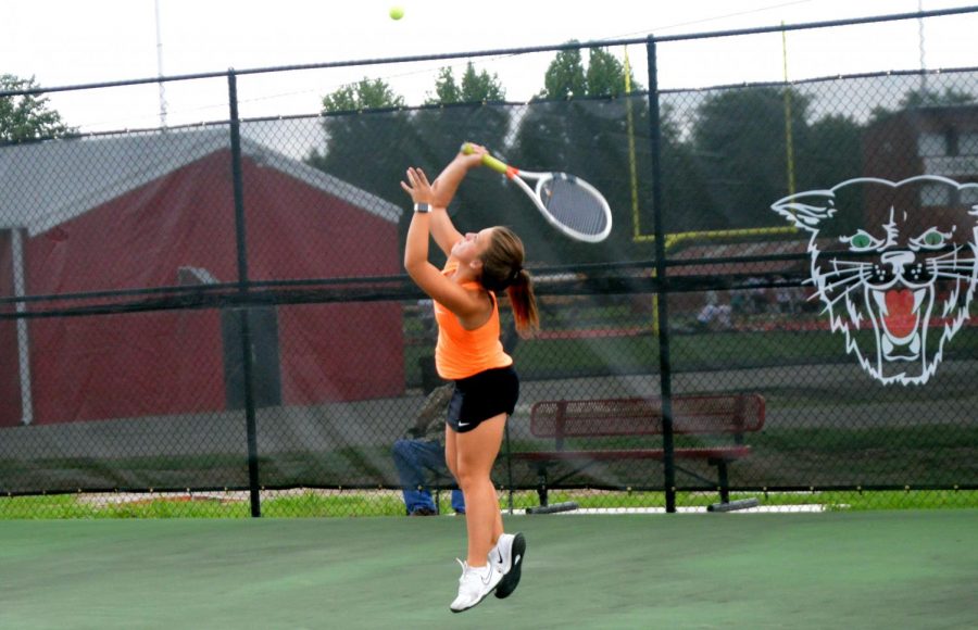 Emily Ford practices serving before her first match