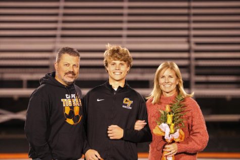 Senior Sam Cairns stands with his family at Senior Night